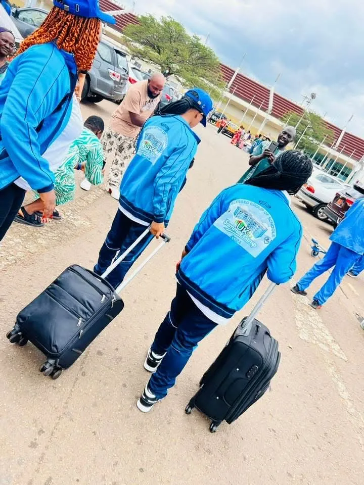 BGS students in branded tracksuits departing for the London Summer Camp programme